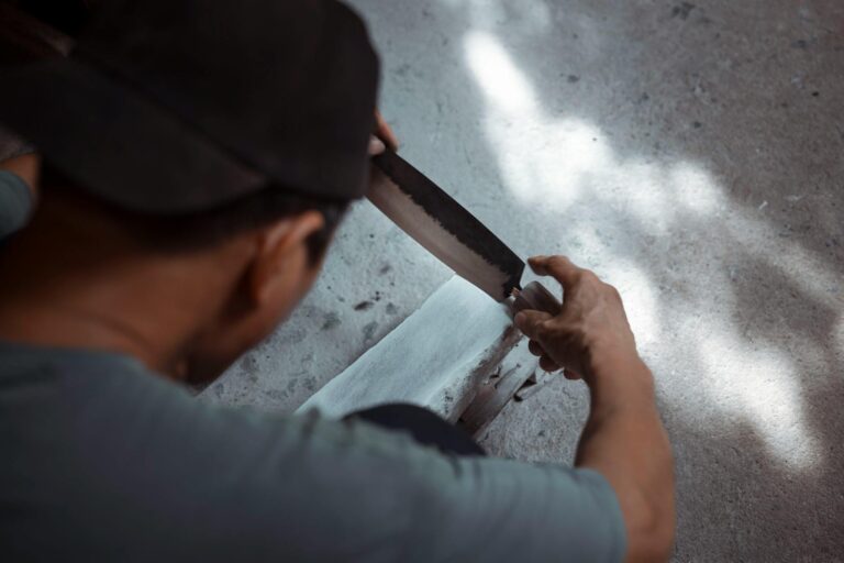 Sharpening a chef's knife on a whetstone with water
